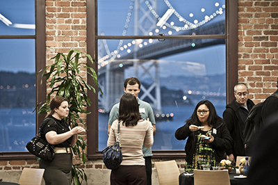 Alumni enjoy each other's company, and the view, at the San Francisco campus.