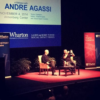 Bobby Turner, W'84, and Andre Agassi take a picture of their Penn audience during the Lauren & Bobby Turner Social Impact Executive Speaker Series event.