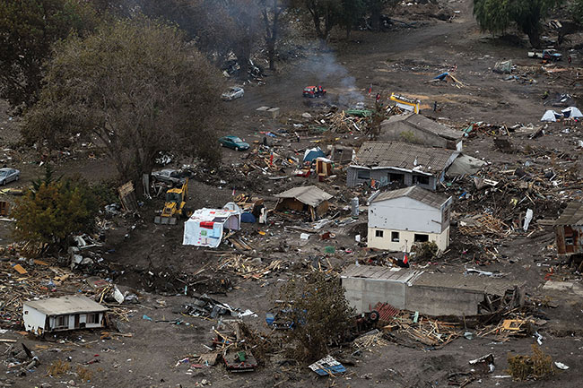 Destroyed homes and debris in Constitution, Chile, a week after the massive earthquake and tsunami on Feb. 27, 2010 (bottom).