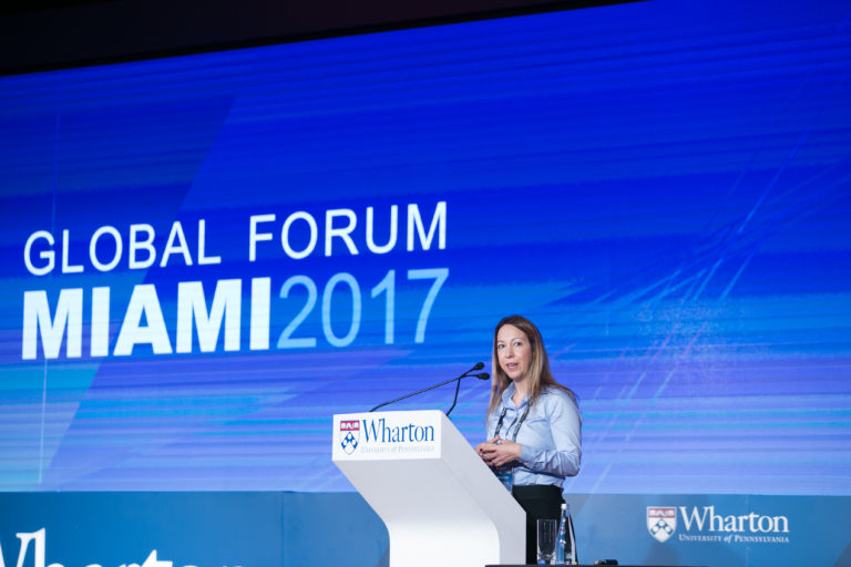 Sonia Rodriguez, W’93, president of the Wharton Alumni Club of South Florida, hosting the forum